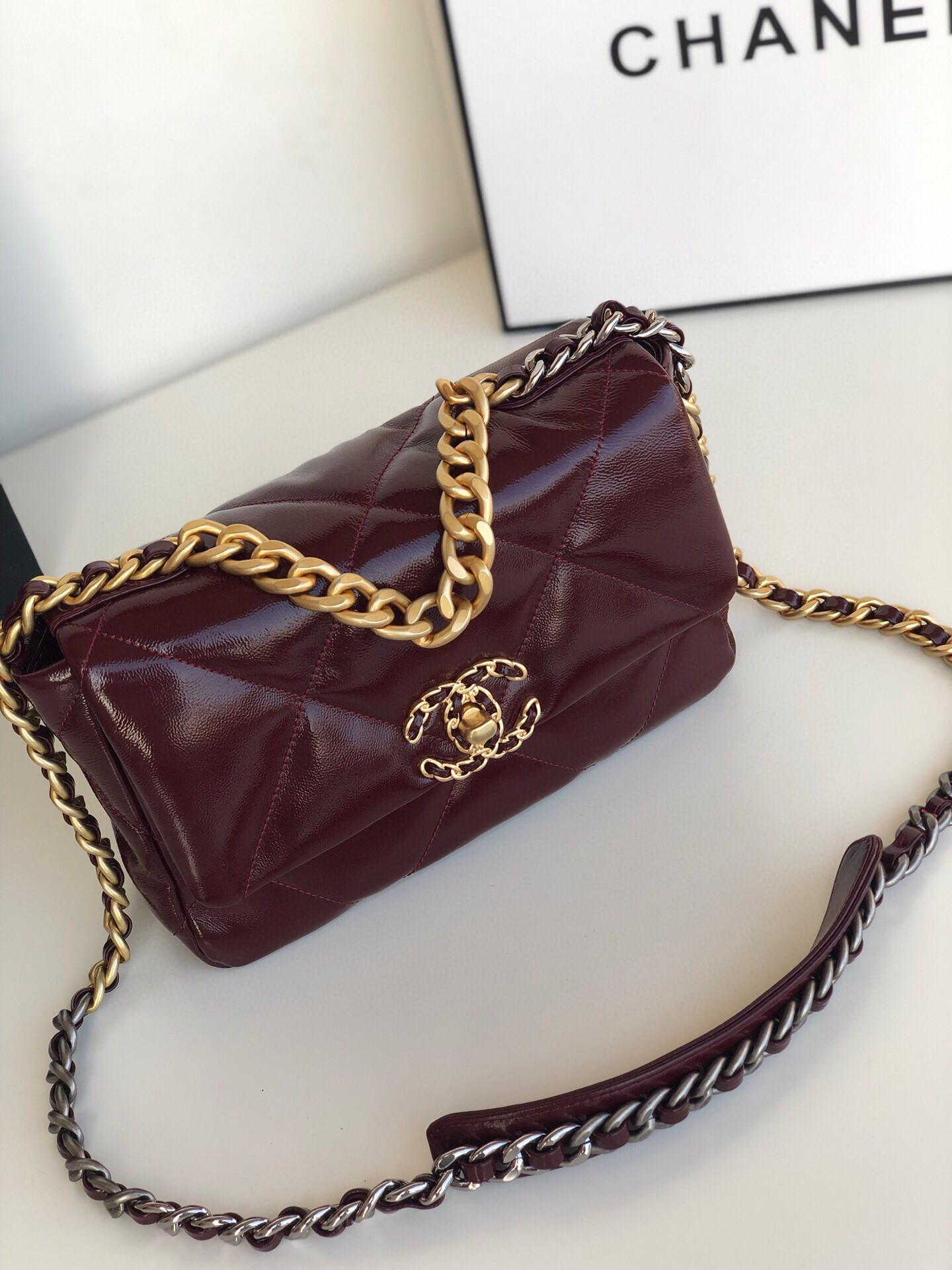 Ch*el 19 handbag shiny leather, gold-tone, silver-tone & ruthenium-finish metal dark red 6.2 × 10.1 × 3.5 in