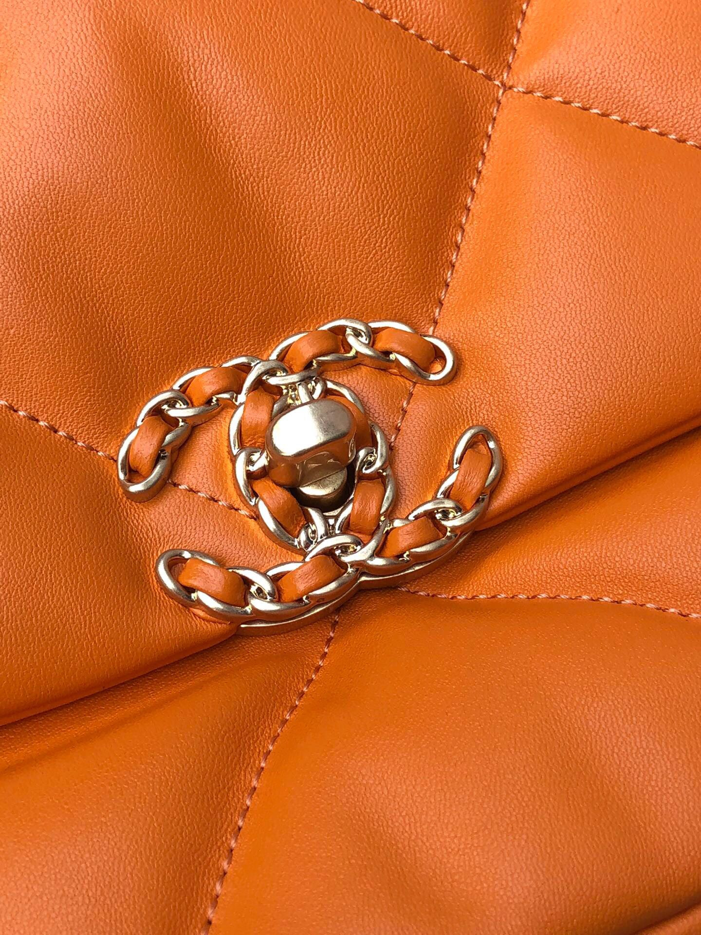 Ch*el 19 large handbag shiny leather, gold-tone, silver-tone & ruthenium-finish metal orange 7.8 × 11.7 × 3.9 in