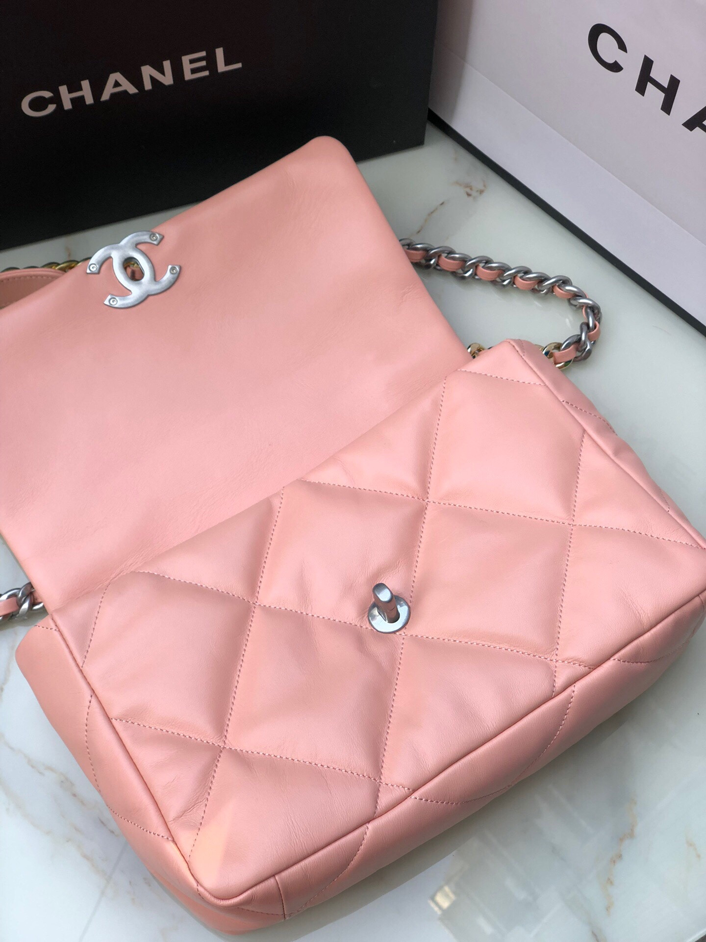 Ch*el 19 large handbag shiny leather, gold-tone, silver-tone & ruthenium-finish metal light pink 7.8 × 11.7 × 3.9 in
