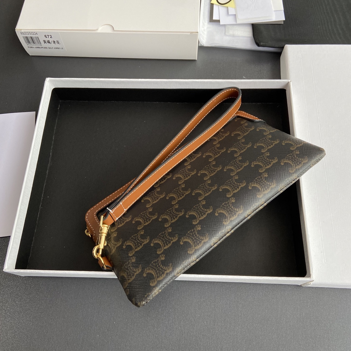 Ce**e long pouch with strap in triomphe canvas and calfskin 21.5x11.5x1cm